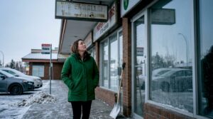 Property manager inspecting Calgary retail entrance in winter