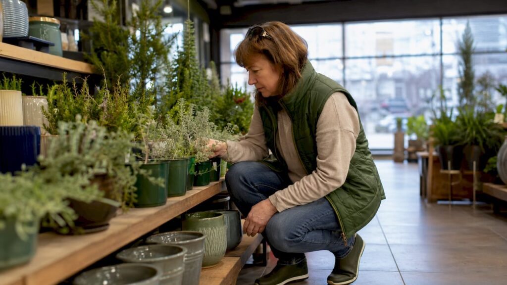 Woman selecting plants at Calgary garden centre