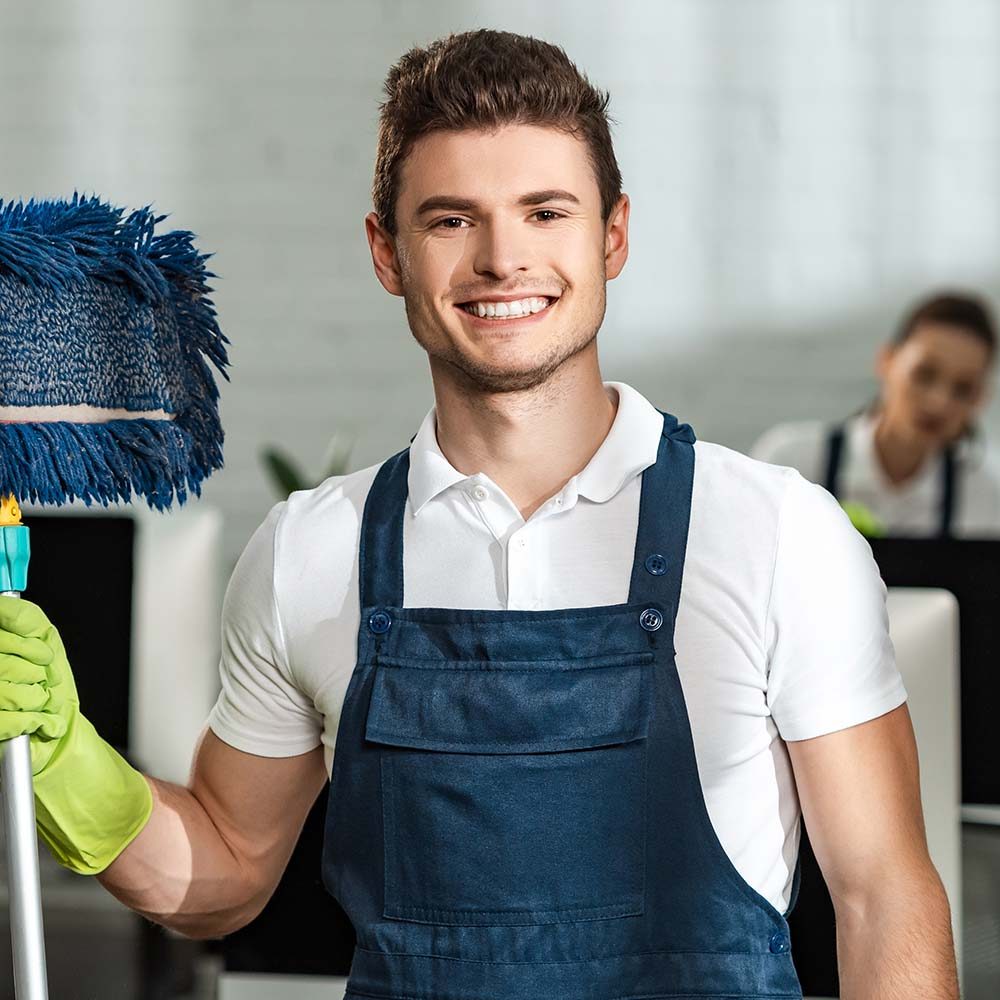 cheerful-cleaner-holding-mop-while-looking-at-came3-NANDH2L.jpg
